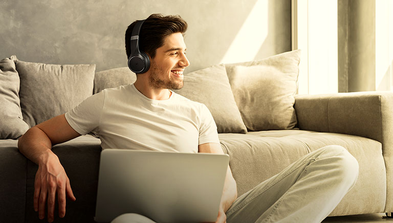 Model sits enjoying the latest MOTO XT 220 Headphones - Content image
